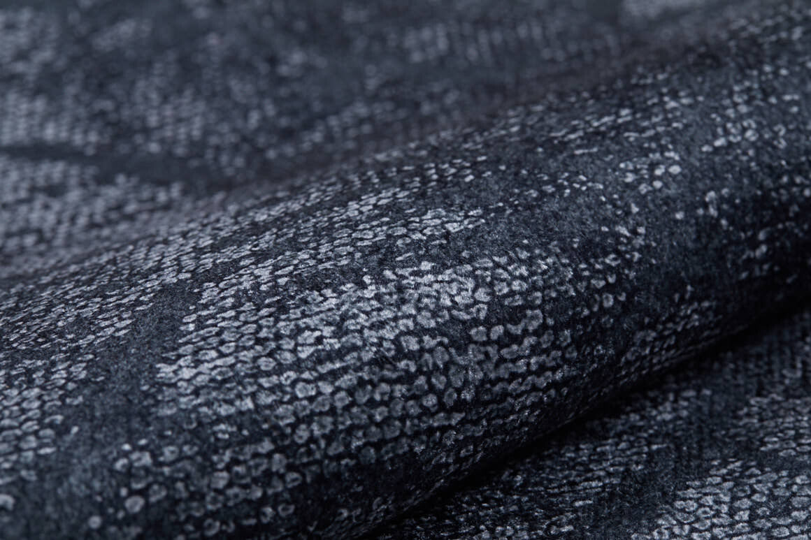 Close-up of the Geometric Gems - Washable Rug - JR1342 (Custom Size), featuring a textured, reptile-inspired black and grey pattern. This washable rug is ideal for high-traffic areas and easy to maintain.