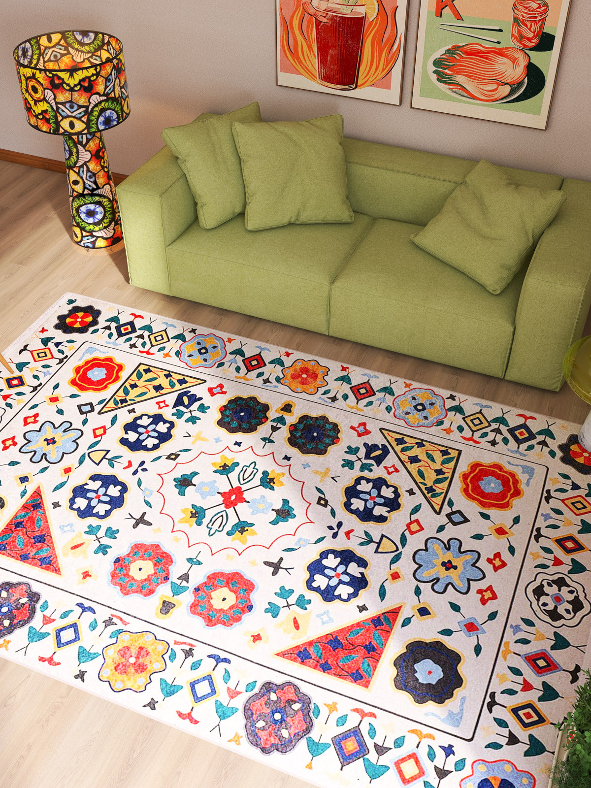 A vibrant living room featuring a light green sofa, the Global Gathering - Washable Rug - JR608 (Custom Size), a matching patterned lamp, and two abstract art prints with bold floral and geometric designs—ideal for high-traffic areas.