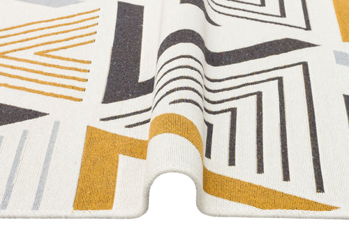 Load image 1 in gallery view. A close-up of the Golden Fog - Washable Double-Sided Kilims - AR18 shows a folded rug with a black, yellow, and gray geometric pattern on white, crafted from recycled cotton for a modern, sustainable look.