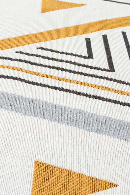 Load image 1 in gallery view. Close-up of the "Golden Fog" AR18 washable double-sided kilim, showcasing a geometric pattern in mustard yellow, gray, and black with lines, triangles, and shapes on a textured white background.