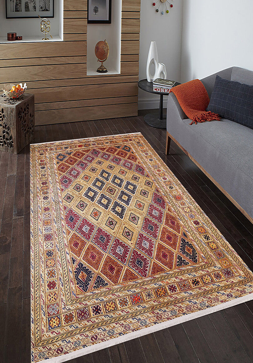 The Grandiose Grace - Washable Rug - JR44 (Custom Size) with vibrant red, yellow, and blue diamond patterns adds a pop of color to a modern living room, complementing a gray sofa and orange throw-on dark wood floors—ideal for high-traffic areas.