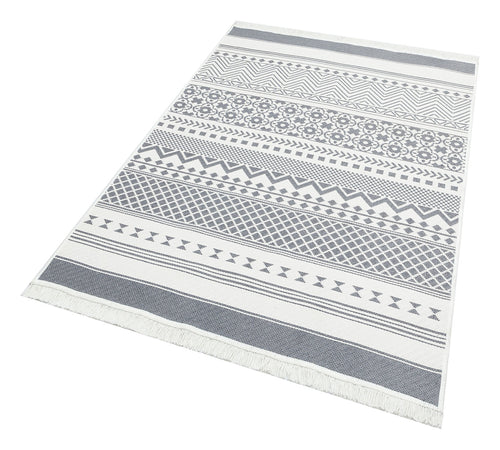 Load image 1 in gallery view. Grey Drift - Washable Reversible Kilims - AR07 is a rectangular flatwoven rug with white and grey geometric patterns—stripes, triangles, diamonds, and circles—and fringed short edges, offering a modern tribal look in a washable kilim style.
