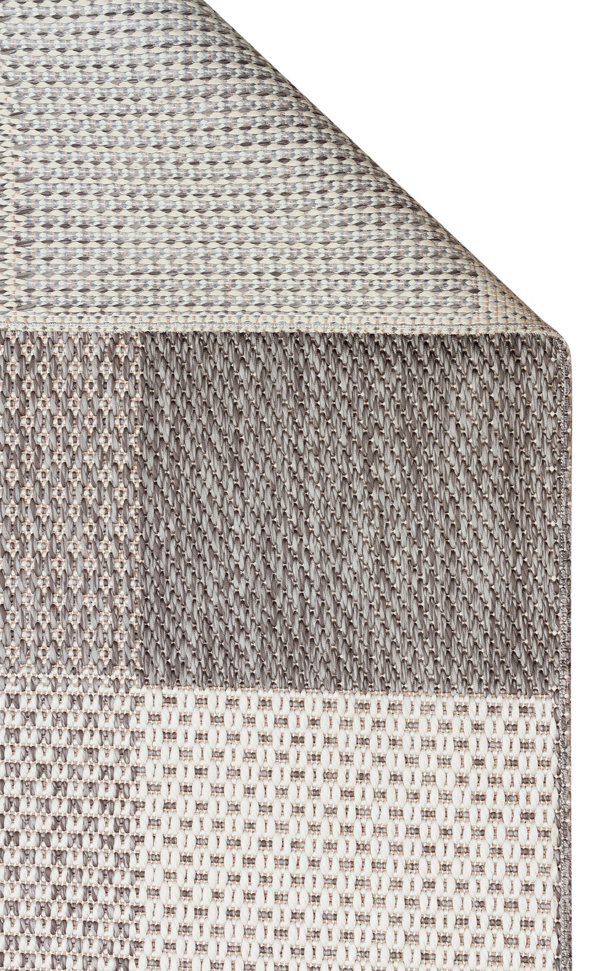 A close-up of the Grey Fold - Kilim - MNO01 rug corner, highlighting overlapping sections with various woven patterns in beige, taupe, gray, and touches of anthracite from the checkered design.
