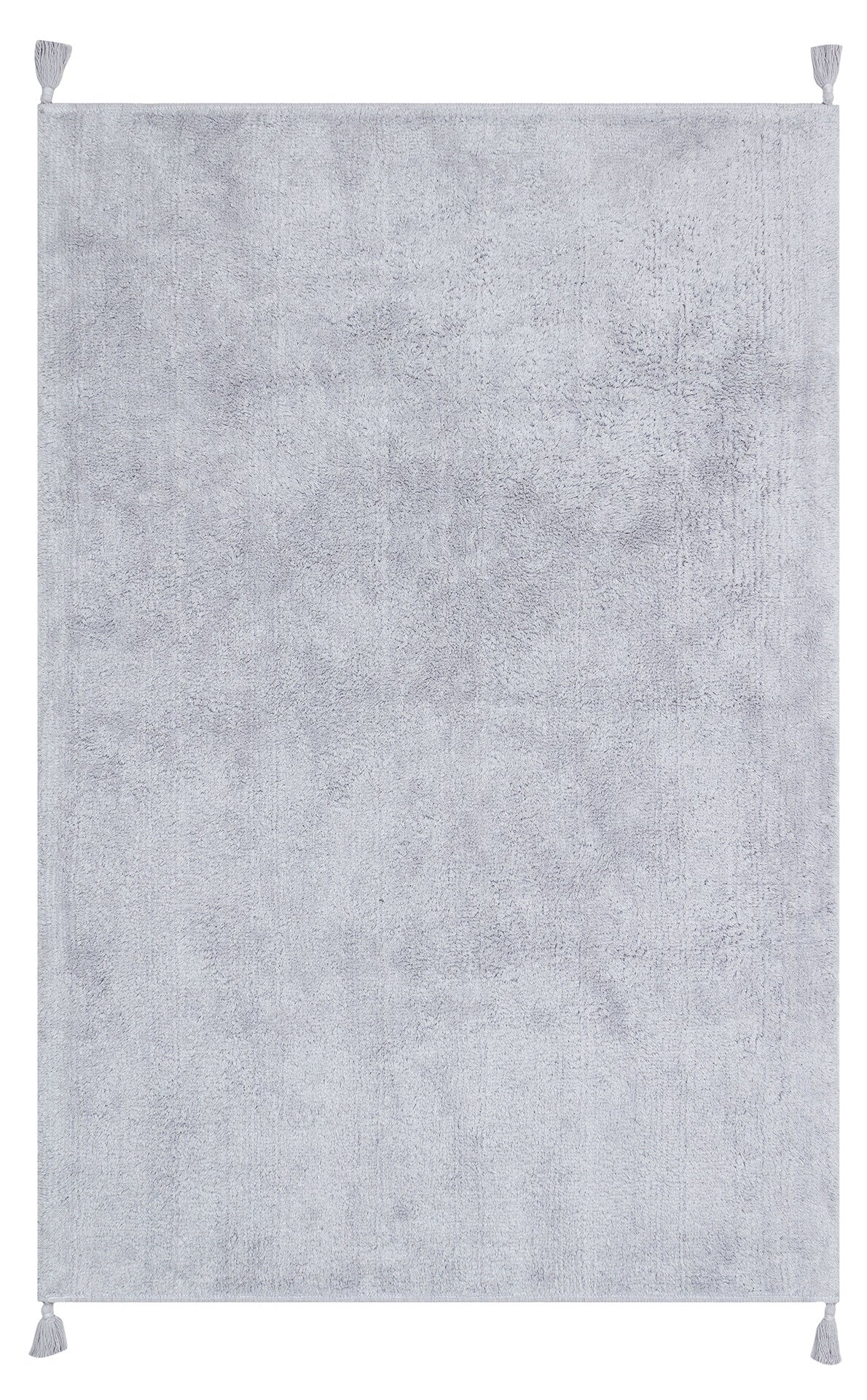 The Grey Snug - Washable Shaggy - CBNPLAIN is a large, rectangular grey cotton rug with a soft, plush texture and tassels at each corner. Its plain design with no patterns suits any modern bedroom and it's easy to wash.