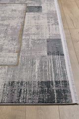 The GridWave Silver Premium Rug - M426A, a modern minimalist piece with an abstract distressed pattern in gray, white, beige, and light purple plus short fringe edges, is displayed on a light wood floor.
