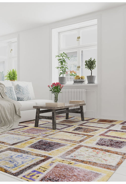 Load image 1 in gallery view. A bright living room features a white sofa with blue and white pillows, a wooden coffee table with books and pink flowers, plants on the windowsill, and the Gridiron Glow - Washable Rug - JR183 (Custom Size) ideal for high-traffic areas.