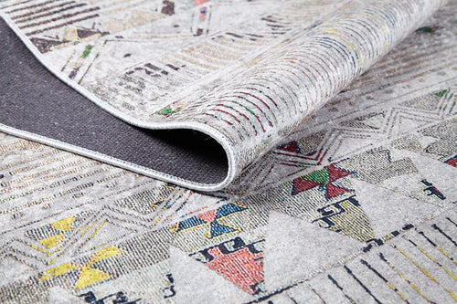 Load image 1 in gallery view. A close-up of the Gypsy Glam - Washable Rug - JR1716 (Custom Size) shows its geometric patterns and colorful accents on a light backdrop, with one corner folded to reveal the textured underside.