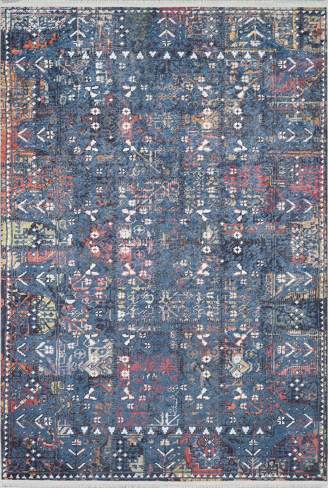 The Gypsy Glitz - Washable Rug - JR1650 (Custom Size) features an intricate distressed pattern with blue, red, yellow, and white geometric motifs and a decorative border—perfect for high-traffic areas.