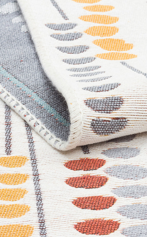 Load image 1 in gallery view. A close-up of the Harmony Weave - Washable Reversible Kilims - AR34 shows a folded corner, with gray, yellow, and orange oval rows on cream. Its texture and stitching reflect contemporary style and quality craftsmanship.