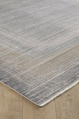 A close-up of the Harmony in Contours Modern Bordered Rug - EW5743, featuring a subtle gray and beige gradient, minimalist design, slight texture, machine-made quality, fringe detailing, and set on a light wood floor.