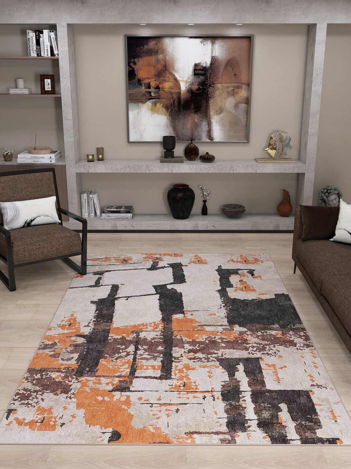 A modern living room features a beige wall, abstract art, built-in shelves with decor, brown and black armchairs, a brown sofa, and the Heirloom Touch Washable Rug - JRN42 (Custom Size) in orange, black, and beige—perfect for high-traffic areas.