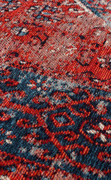 Close-up of the Heritage Blend - Washable Kilims - AND02, showcasing intricate red, blue, and white motifs on a textured woven surface. This washable kilim offers a slightly distressed look—an ideal choice for allergy-conscious spaces