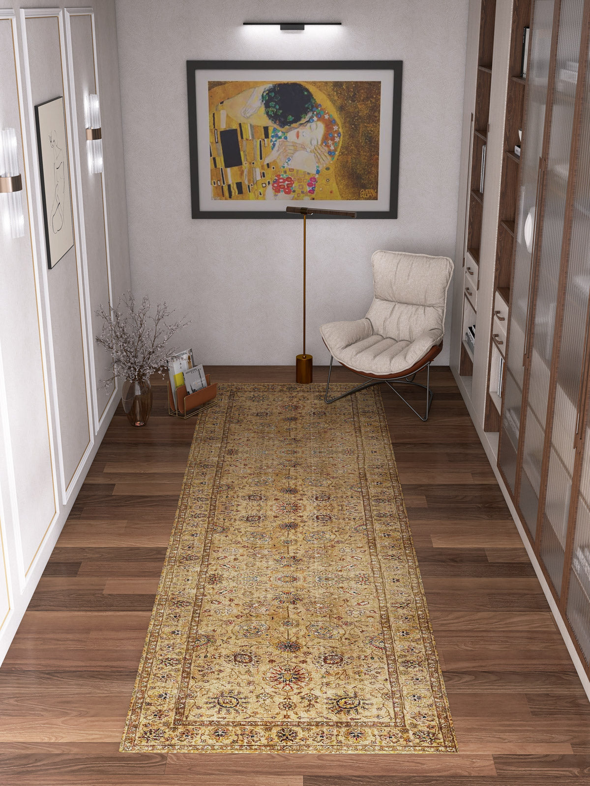 A hallway with wooden floors showcases the Heritage Threads - Washable Rug - JRN1007 runner, paired with a cushioned chair, wooden floor lamp, tall vase with branches, shelf of books, and framed abstract wall art for timeless traditional style.