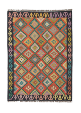The Heritage Weave - Handwoven Kilim is a colorful wool rug with vibrant diamond patterns in red, yellow, blue, green, and orange and a geometric border in black, purple, yellow, and pink. This flatweave features handwoven craftsmanship and fringed edges.