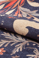 Close-up of the Holiday Heart Washable Area Rug - MDJ001 shows a textured fabric with cream birds, leaves, and pink flowers on dark blue. This multicolor rug is ideal for high-traffic areas and highlights its intricate decorative pattern.