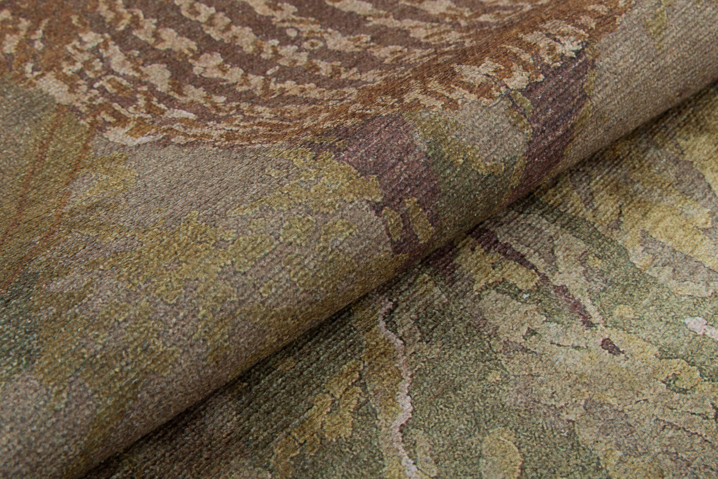 Close-up of Dreamweaver's Loom - Washable Rug - JRS001 (Custom Size), folded to show its textured, earth-toned abstract pattern in brown, green, and beige with swirling leaf-like designs—ideal for high-traffic areas.