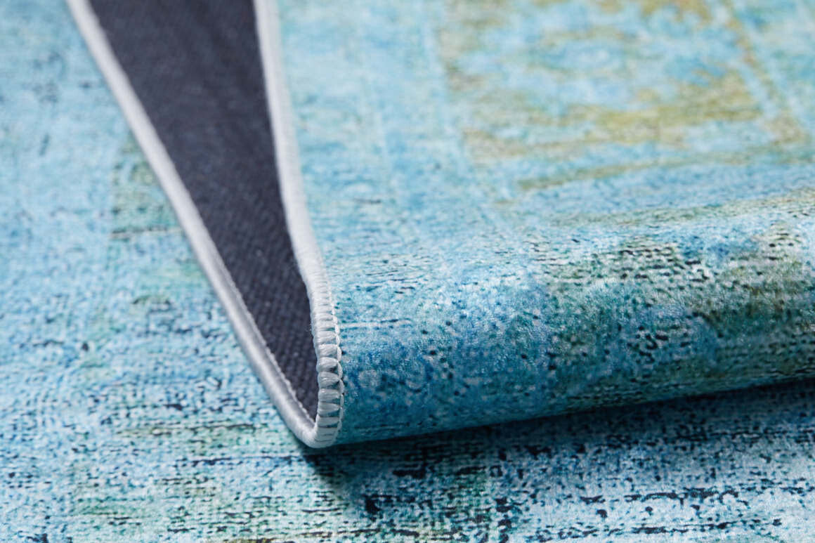 A close-up of the Imperial Jewel - Washable Rug - JR162 (Custom Size) in blue and green, showing its textured surface, stitching, and dark backing. This washable rug is perfect for allergy-sensitive homes.