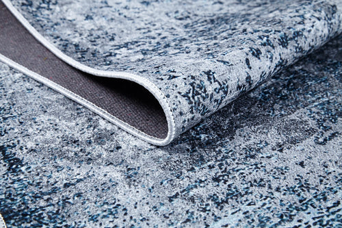 Load image 1 in gallery view. A close-up of the Imperial Lace - Washable Rug - JR1607 (Custom Size) shows its textured blue surface, curled corner revealing the underside and edge stitching—ideal for high-traffic areas.