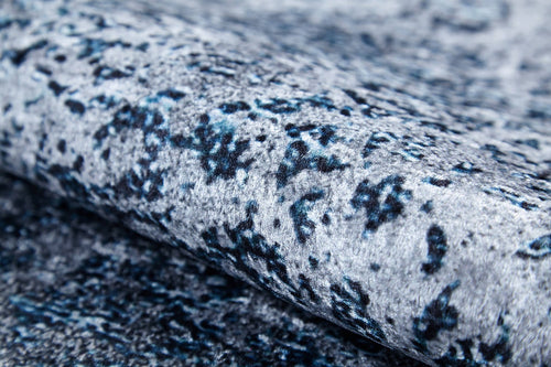 Load image 1 in gallery view. Close-up of the Imperial Lace - Washable Rug - JR1607 (Custom Size) in textured blue with a mottled gray, blue, and black pattern, soft fuzzy surface, rolled edge—ideal for high-traffic areas and easy care thanks to its washable design.