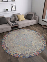 A modern living room with a gray sectional, neutral throw pillows, floating white shelves, and the Imperial Weave - Washable Rug - JR1969 with a blue and red border—perfect for high-traffic areas on dark hardwood floors.