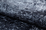 A close-up of the Infinity Garden - Washable Rug - JR1749 (Custom Size) in gray-anthracite, featuring a textured abstract black and gray geometric pattern—durable and ideal for high-traffic areas.