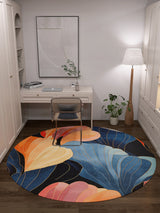 A modern home office with a white desk, laptop, chair, standing lamp, potted plant, and the Iris Abstract Floral Washable Rug - MDJ009 featuring multicolor abstract leaf designs in blue, orange, and yellow.