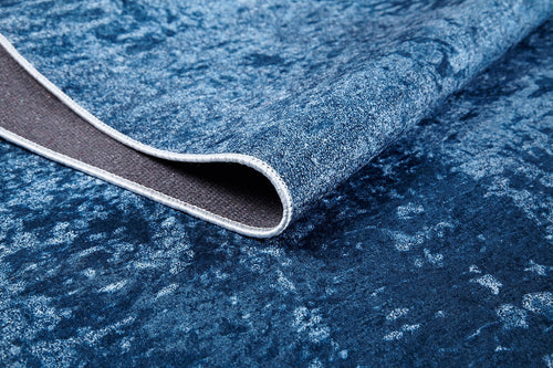 Load image 1 in gallery view. A close-up of the Ivory Whisper - Washable Rug - JR1628 (Custom Size) with a corner folded over, showing its non-slip backing and soft surface—ideal for high-traffic areas and easy cleaning.