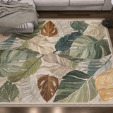 The Amazon Veil - Washable Rug (JRS010) features a large, colorful leaf pattern in green, brown, and beige. Ideal for high-traffic areas, it suits wooden floors and gray sofas, offering a subtle floral novelty design that’s easy to clean.
