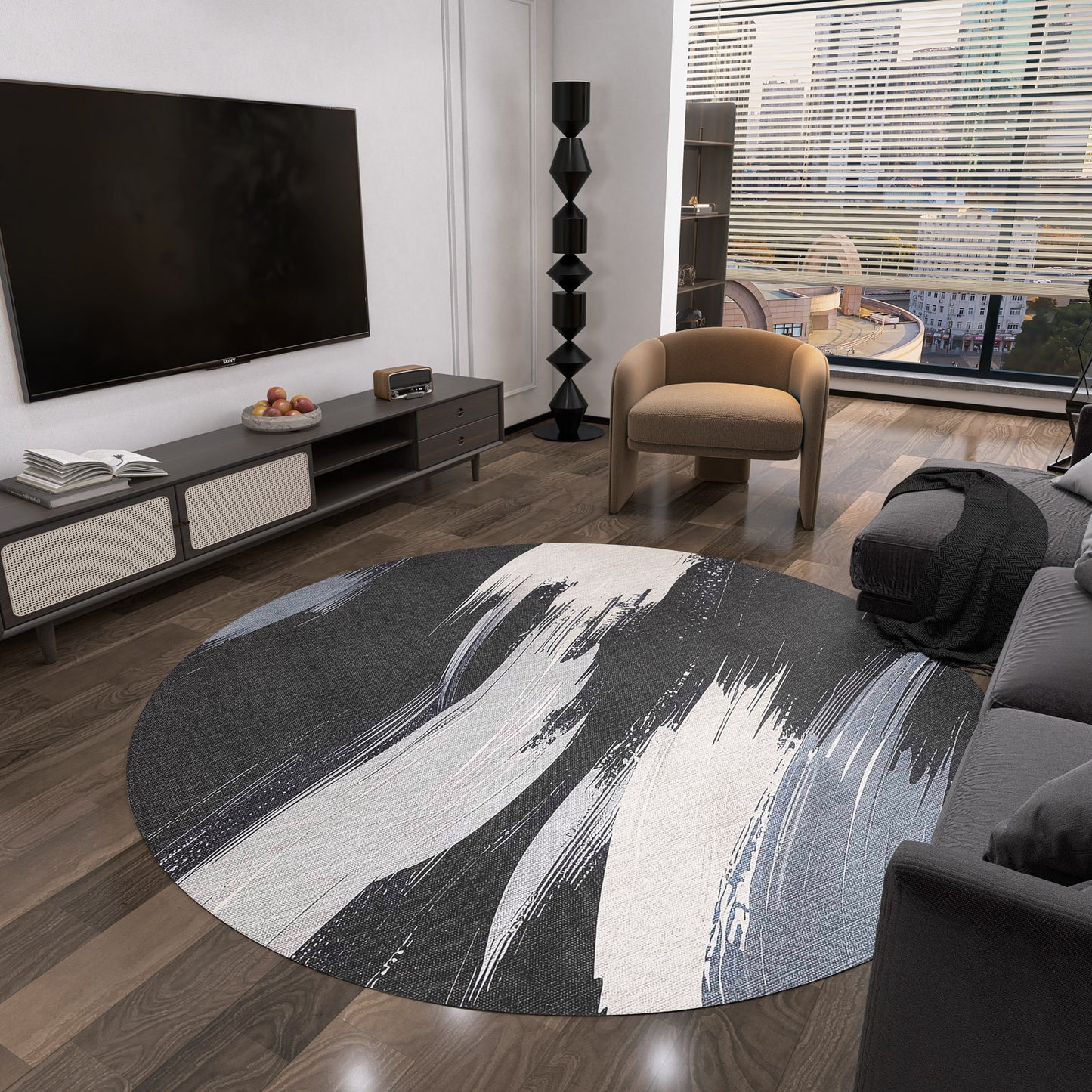 A modern living room with the Shadow Flow - Washable Rug - JRS011 in black, white, and gray on dark wood floors, a gray sofa, brown armchair, flat-screen TV, low cabinets, and large windows overlooking a cityscape.