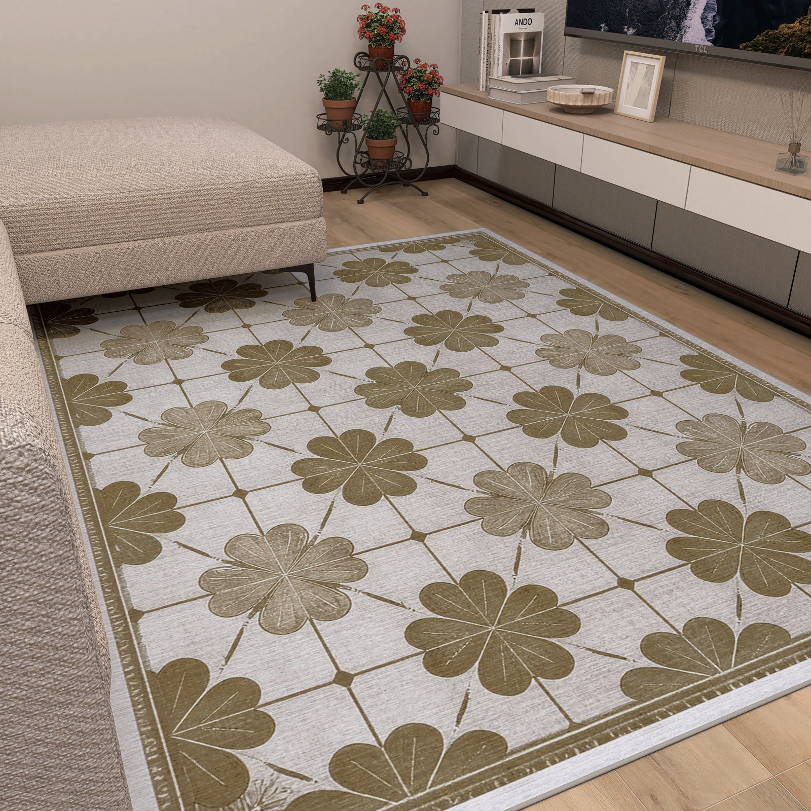 A living room with a beige sofa and the Ivory Clover - Washable Rug (JRS014), featuring bold clover patterns for a floral touch—ideal for busy spaces. Potted plants and a low TV unit bring added coziness to the room.