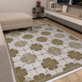 A living room with a beige sofa and the Ivory Clover - Washable Rug (JRS014), featuring bold clover patterns for a floral touch—ideal for busy spaces. Potted plants and a low TV unit bring added coziness to the room.