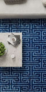 Blue patterned rug with decorative items.