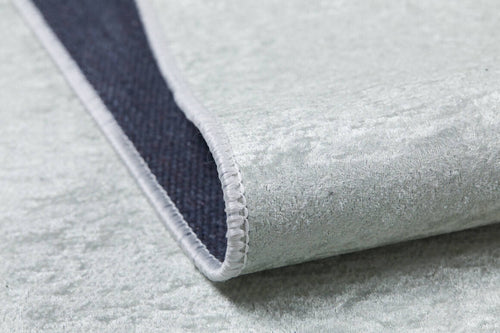 Load image 1 in gallery view. A close-up of the Joyful Elephant - Machine-Washable Rug JRC026 (Custom Size) in light gray, showing its soft, velvety flat weave, white stitched edging, and dark textured underside—an allergy-friendly choice for your home.