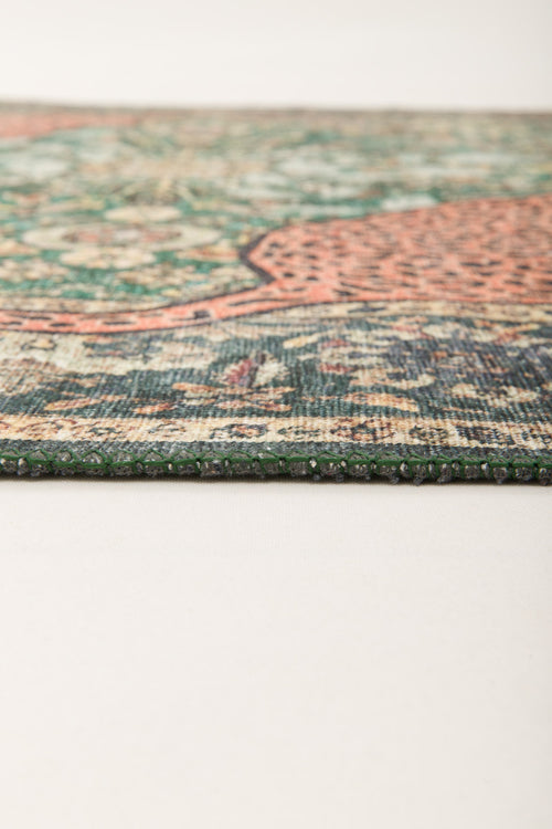 Bild 1 in Galerieansicht laden. Close-up of the Jungle Ember Washable Rug (JR0047) laying flat on a light surface, highlighting its intricate geometric pattern in green, red, and beige.