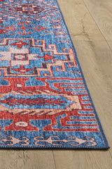 The Kaleidos Authentic Blue Washable Rug - LCC3028 (Custom Size) features intricate geometric patterns in blue, red, white, and pink. Shown on a light wood floor, it’s ideal for high-traffic areas and highlights its unique design and washable texture.