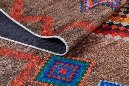 Load image 1 in gallery view. A close-up of the Kilim Kingdom - Washable Rug - JR1536 (Custom Size), featuring a brown woven texture and vibrant red, blue, and green geometric patterns; one corner is folded to show the dark underside—ideal for high-traffic areas.