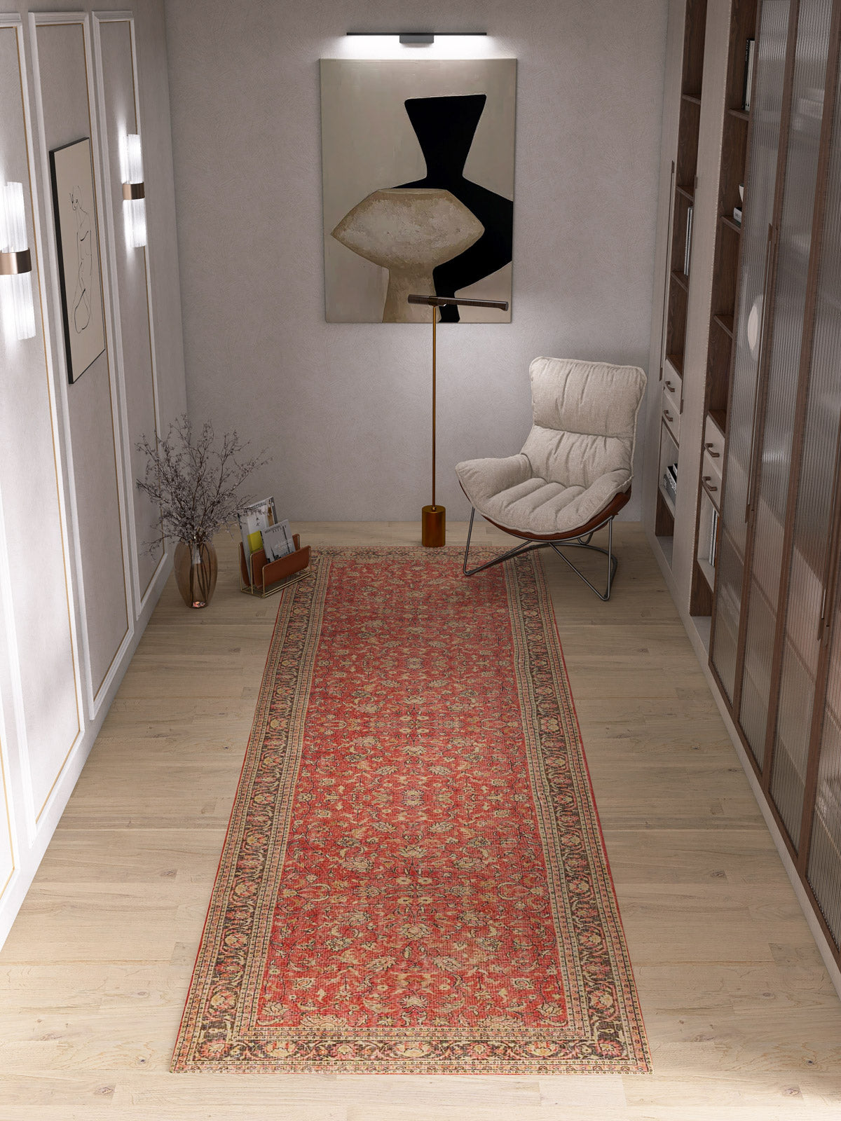 The Legacy Wreath - Washable Rug - JRN1024 (Custom Size) runner lies on a light wood floor in a modern hallway with a cozy lounge chair, abstract wall art, a floor lamp, and shelves with books on the right.