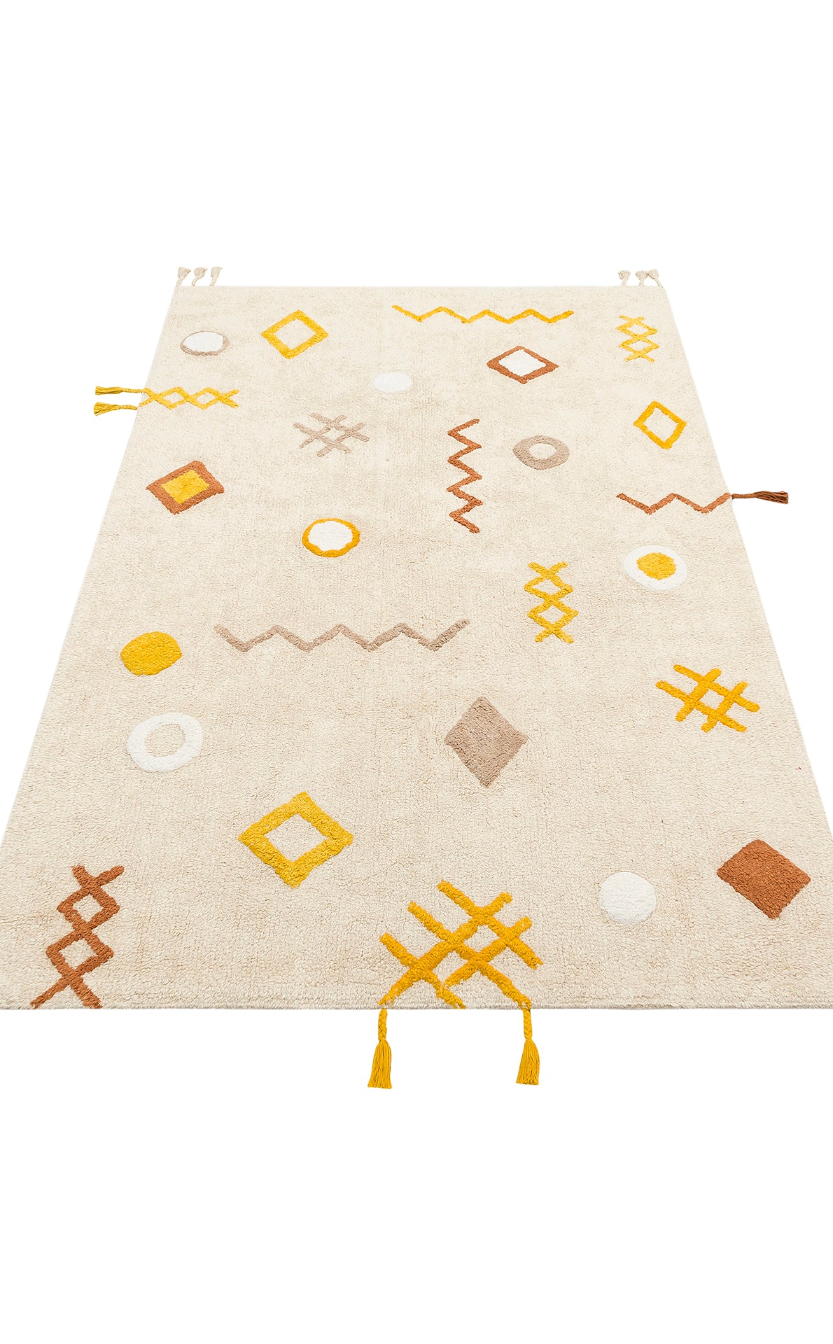 The Little Dream - Washable Shaggy - CBN12 is a beige kids' room rug with plush cotton, abstract yellow, brown, and white geometric shapes—circles, diamonds, zigzags, crosses—and yellow tassels on two corners for a modern touch.