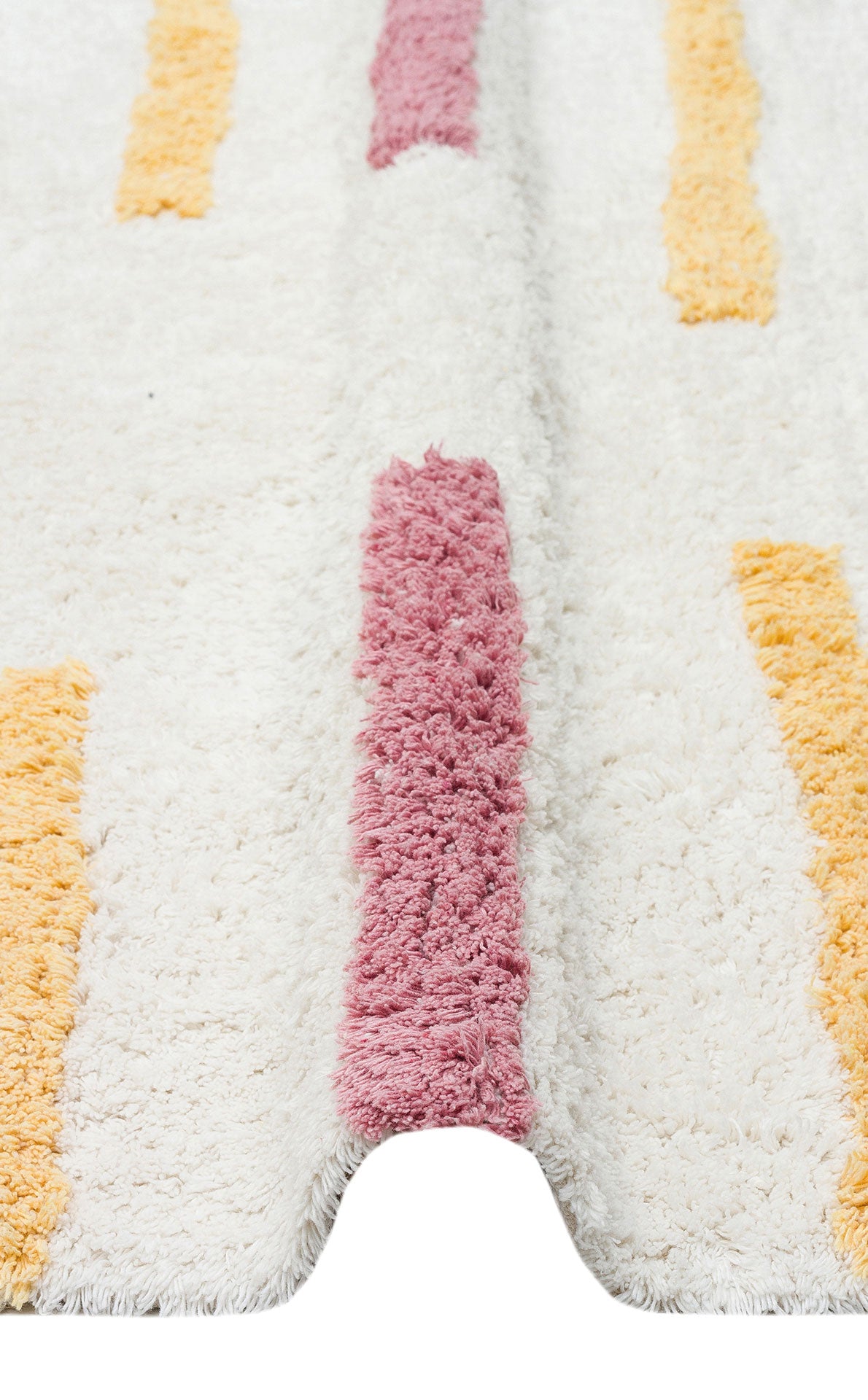 A close-up of the Little Steps - Washable Shaggy - CBN03 rug shows vertical pink and yellow stripes. The white multicolour rug is slightly raised in the center, revealing its plush, thick, and soft texture.