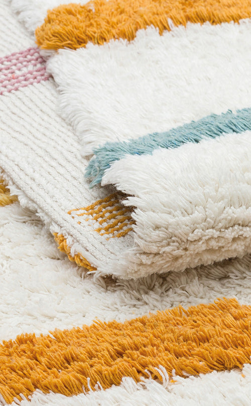 Load image 1 in gallery view. A close-up of the Little Steps - Washable Shaggy - CBN03 rugs, featuring vibrant orange, yellow, teal, and pink stripes with a fluffy textured surface, stacked together as a colorful multicolour set.