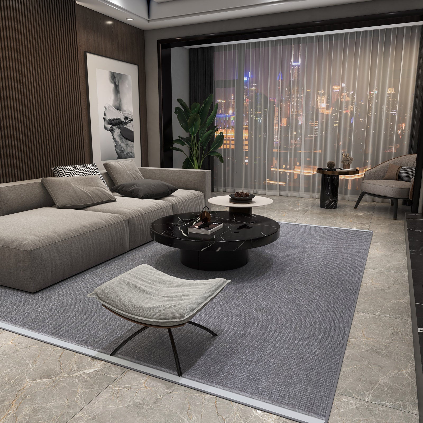 Modern living room with a gray sectional, black round coffee table, lounge chair, and large plant. The Velvet Touch Dark Gray Area Rug - PST005 adds softness, while abstract art and neutral tones frame city views through floor-to-ceiling windows.