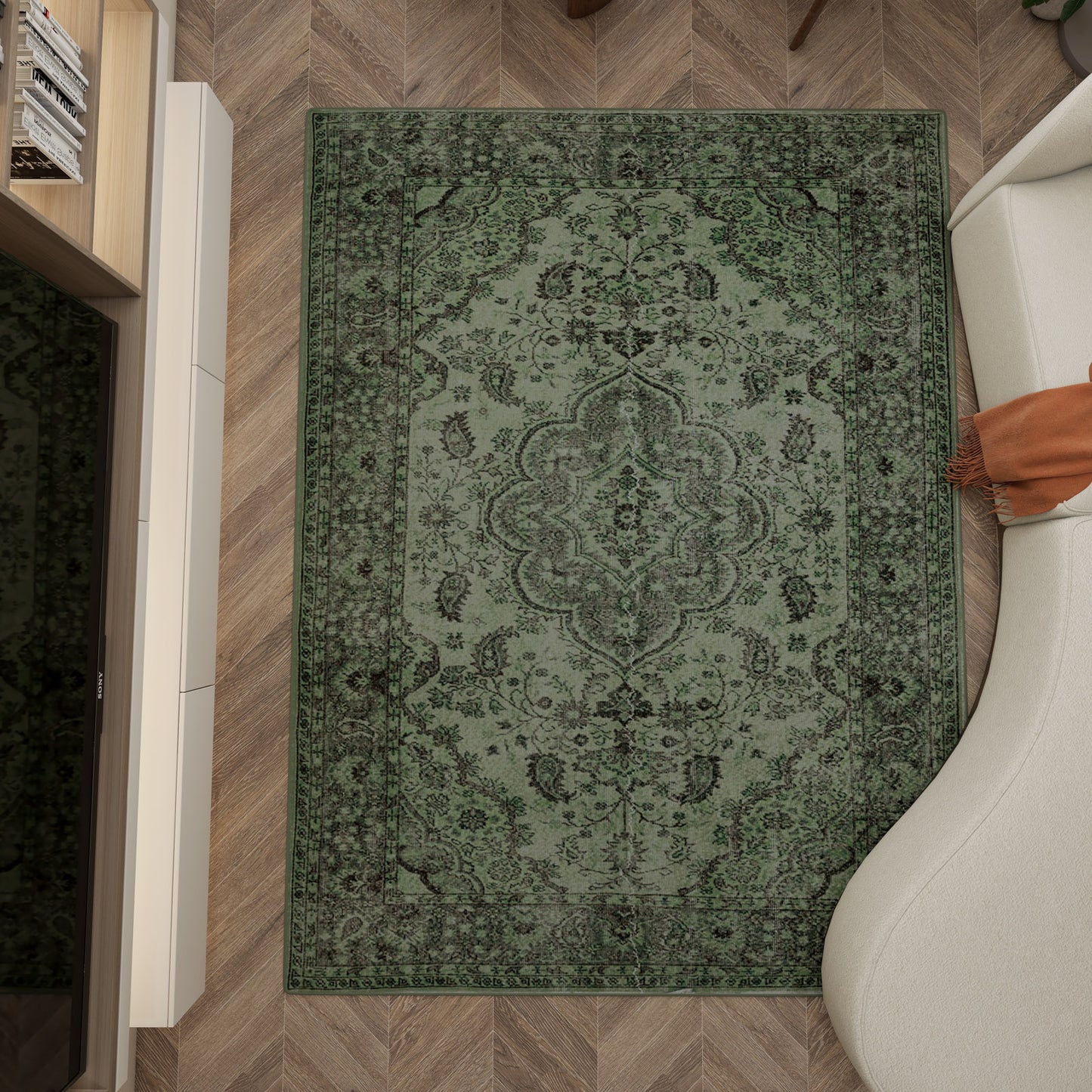 The Royal Vinework - Washable Rug - JRN1009 with a medallion design rests on the herringbone wood floor beside a curved white sofa with an orange throw and a white cabinet.