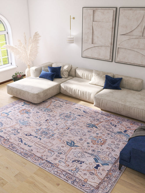 Bild 1 in Galerieansicht laden. A bright living room with a cream sectional sofa, blue accent pillows, the Luminary Beige Gray Washable Rug (LCC3023), pampas grass in a vase, abstract wall art, and natural light from an arched window.