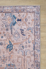 A close-up of the Luminary Beige Gray Washable Rug (LCC3023) shows its ornate flat weave with pink, blue, and cream accents in intricate floral and geometric patterns on a light wooden floor.
