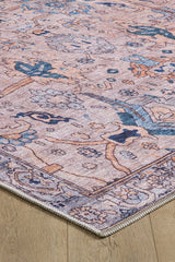 Close-up of the Luminary Beige Gray Washable Rug (LCC3023), showcasing its intricate floral and geometric patterns in muted pink, blue, and beige tones on a light wood floor.