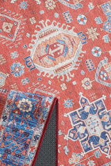 A close-up of the Lunavale Red Blue Washable Rug (LCC3007) shows geometric and floral motifs in orange, blue, cream, and white. One corner is folded to display the blue and red underside—ideal for high-traffic areas.