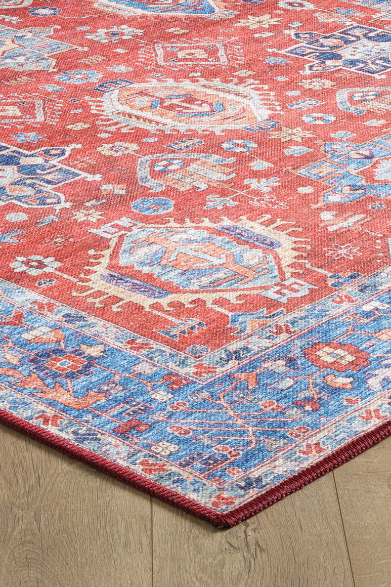 A close-up of the Lunavale Red Blue Washable Rug - LCC3007 (Custom Size), featuring geometric and floral patterns in red, blue, and cream on a wooden floor. Ideal for high-traffic areas with a decorative border; easy to clean.