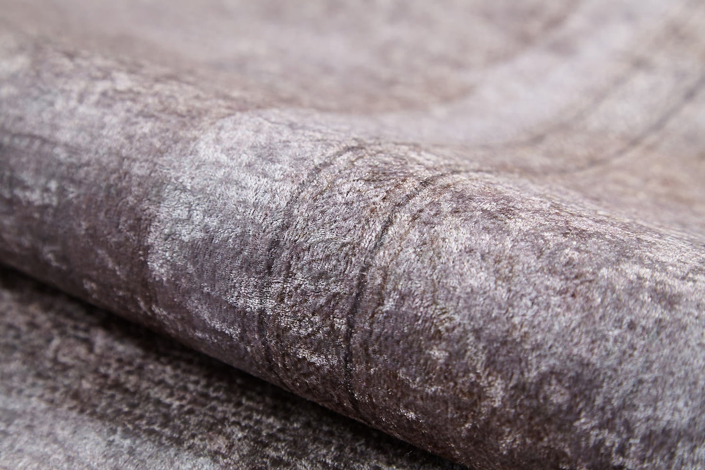 A close-up of the Luxe Borderline - Washable Rug - JR1741 (Custom Size) shows its textured, folded gray fabric with a subtle pattern and soft sheen—perfect for high-traffic areas.