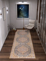 A modern hallway features the Majestic Crest - Washable Rug - JRN1015 runner on dark wood floors, a cushioned chair beneath an abstract painting, a floor lamp, and a vase with twigs.