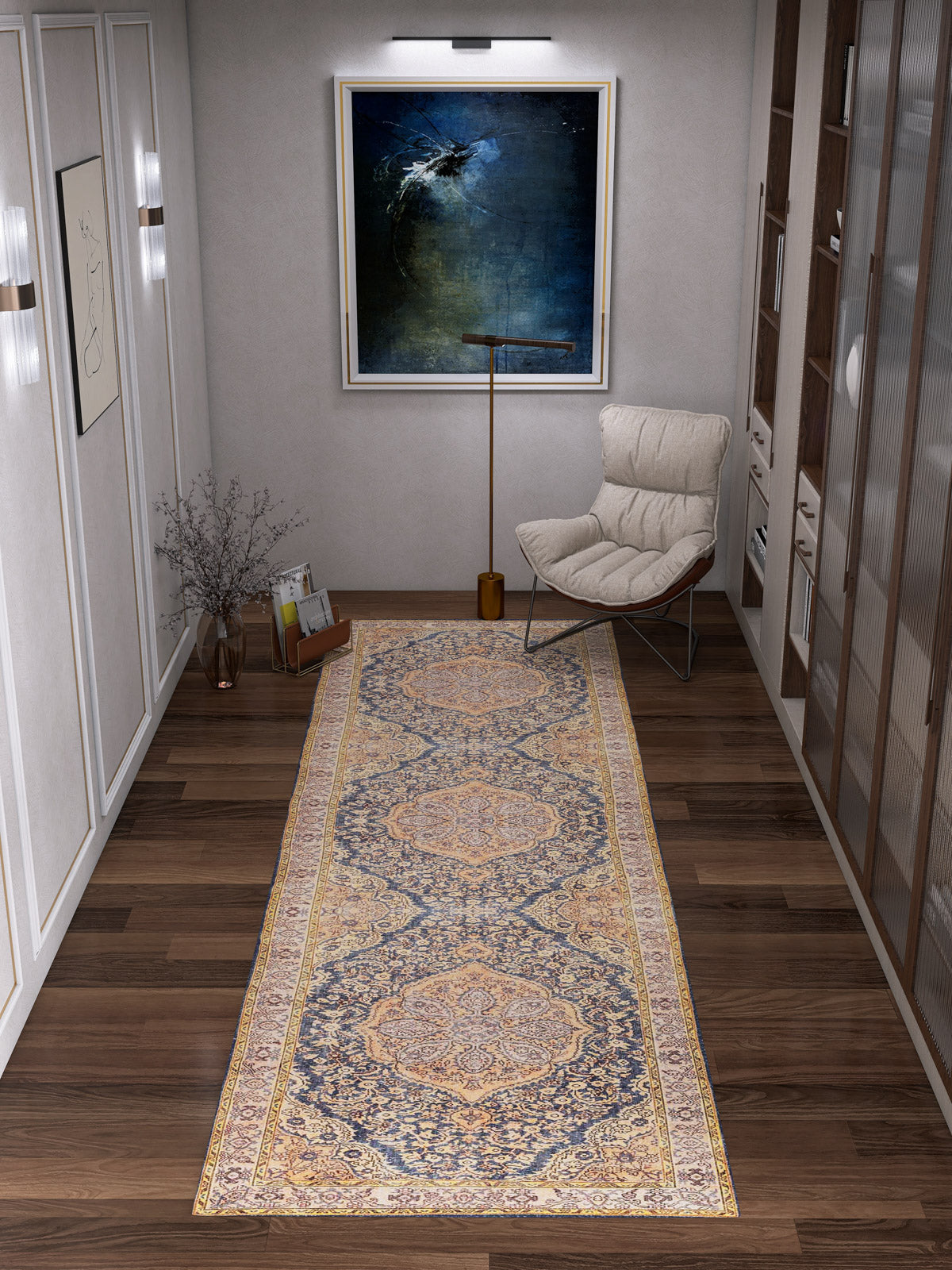 A hallway with wooden floors features the Majestic Crest - Washable Rug - JRN1015 (Custom Size) runner, a modern cushioned chair, floor lamp, vase with branches, and a large abstract painting under a picture light.